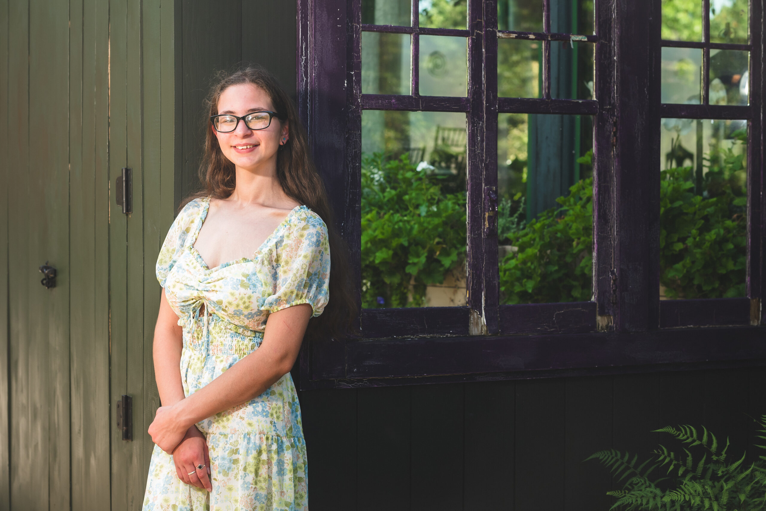 CT senior portrait photography girl in floral dress by garden window