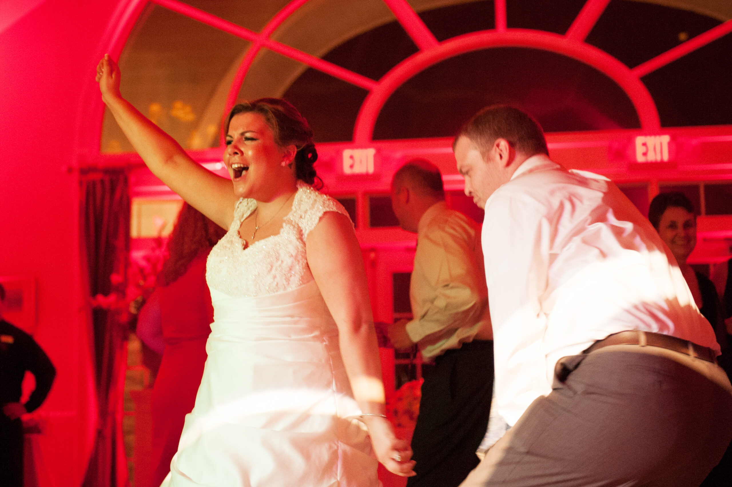 CT wedding DJ bride dancing arms up red uplighting Riverhouse at Goodspeed Station East Haddam CT