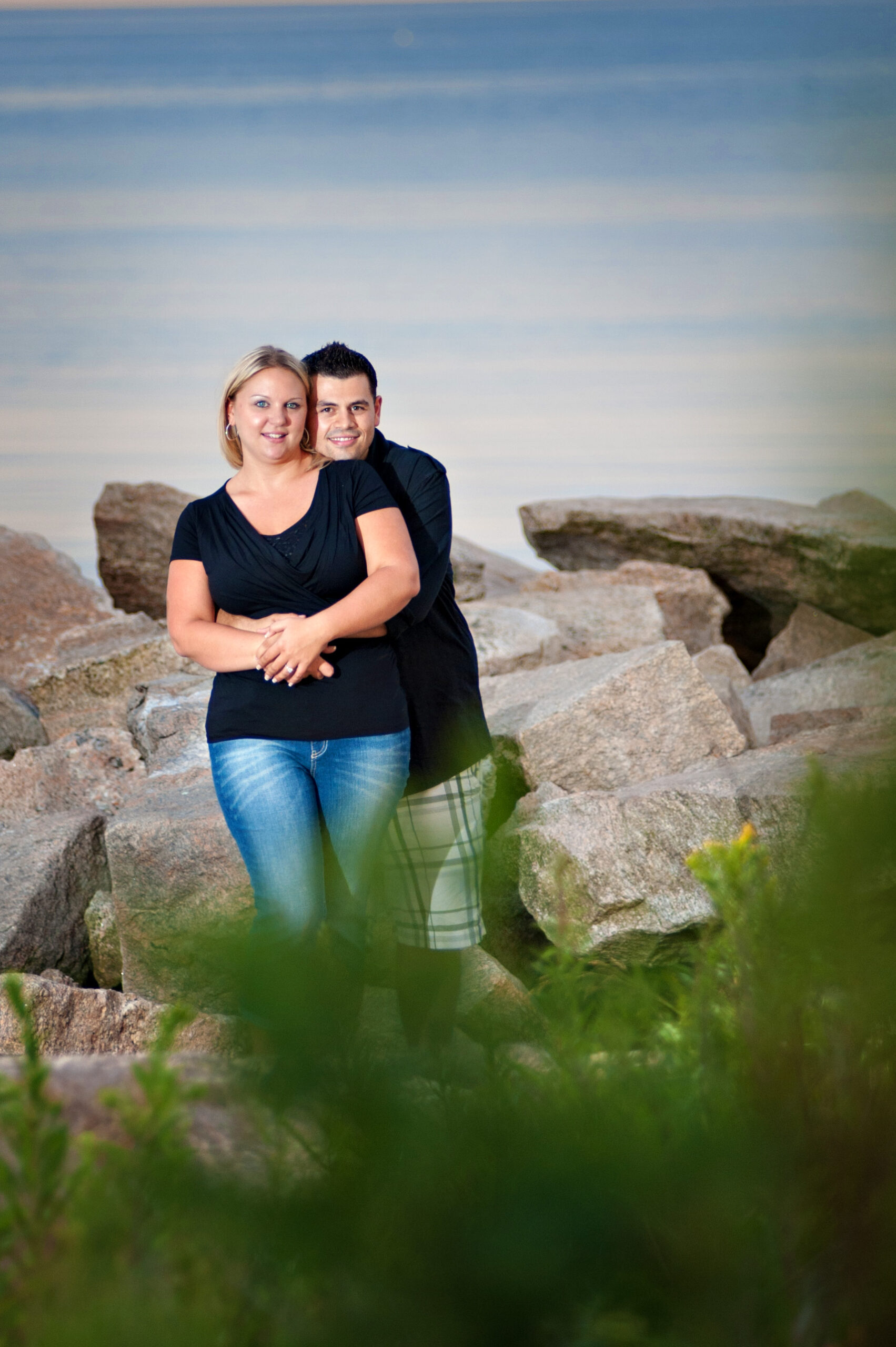 CT engagement photography couple embrace rocks waterfront rocky neck state park Connecticut