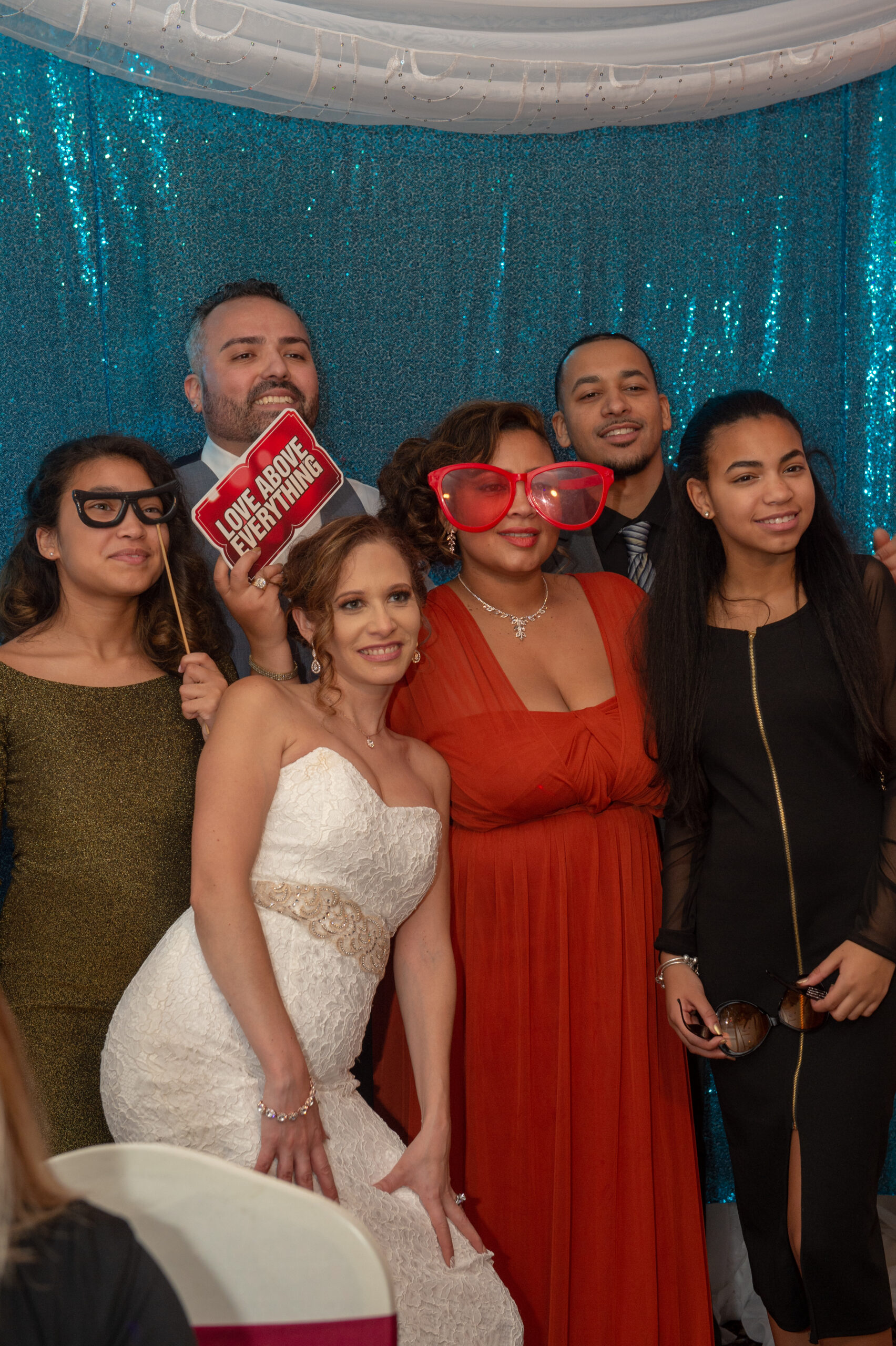 Wedding guests posing with props in a photo booth at Georgina's in Bolton CT