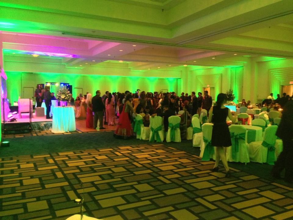 Wedding guests on a green-lit dance floor at Marriott Hartford CT reception