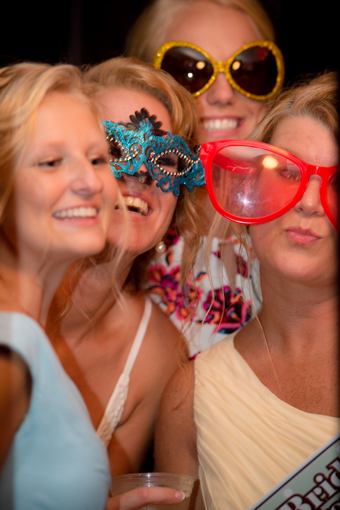 Bridesmaids laughing with oversized glasses props at a Geer Tree Farm CT wedding photo booth