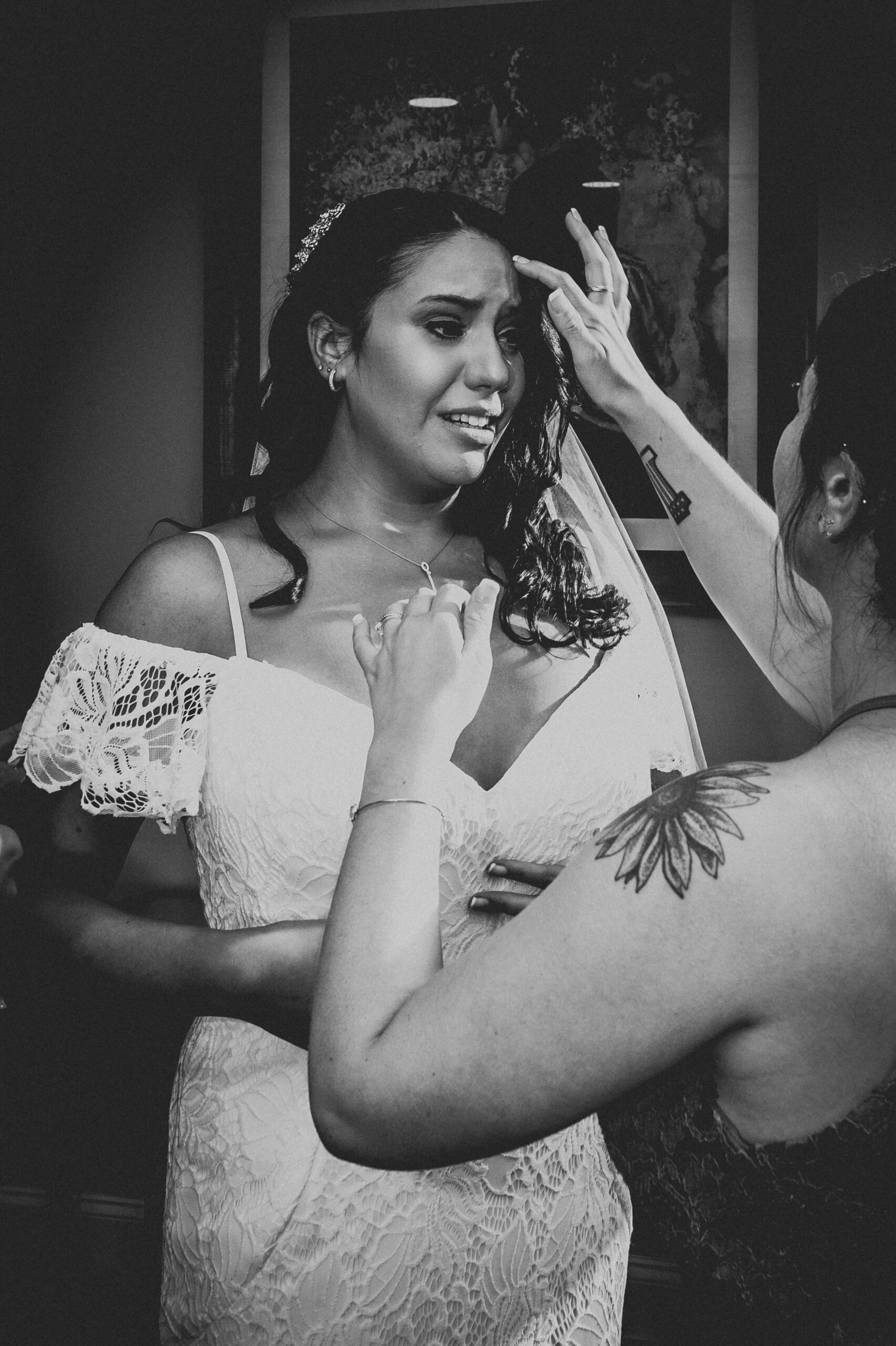 Bride getting emotional while bridesmaid adjusts her veil in black and white at the Cascade in Hamden CT