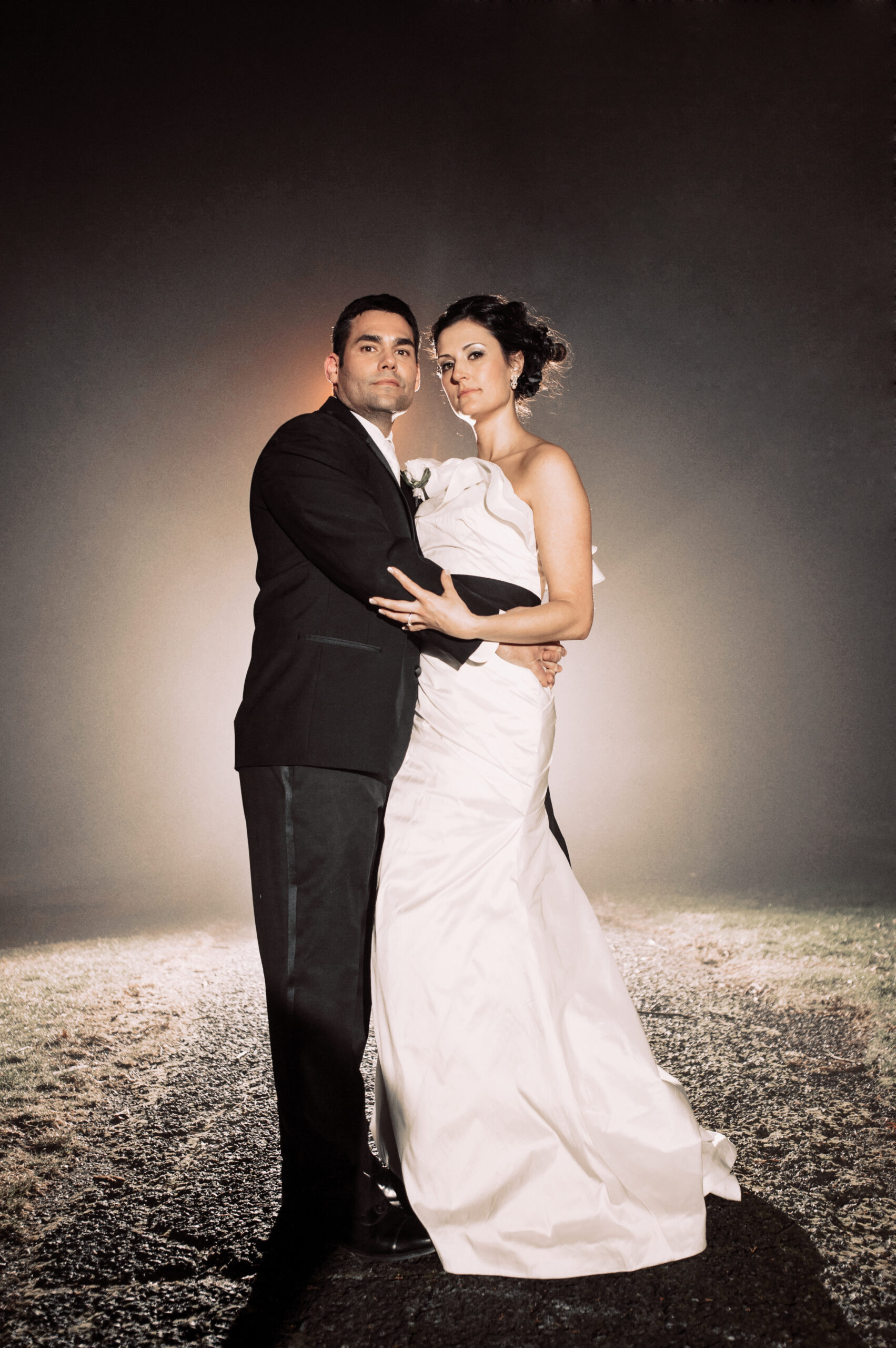 Bride and groom in a dramatic backlit night portrait at Elizabeth Park in West Hartford CT