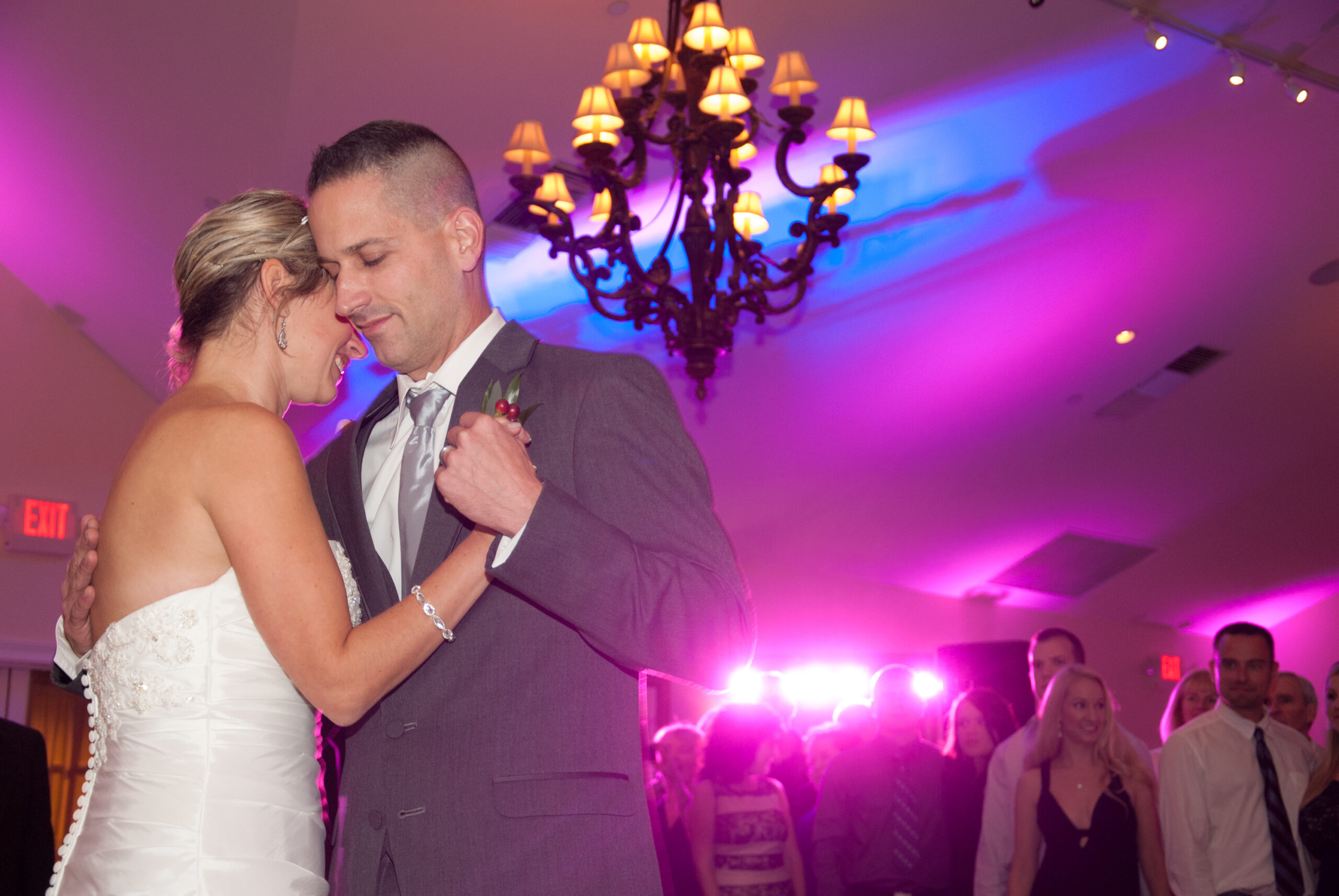 Bride and groom sharing their first dance with pink and blue uplighting at the Riverhouse at Goodspeed Station in East Haddam CT