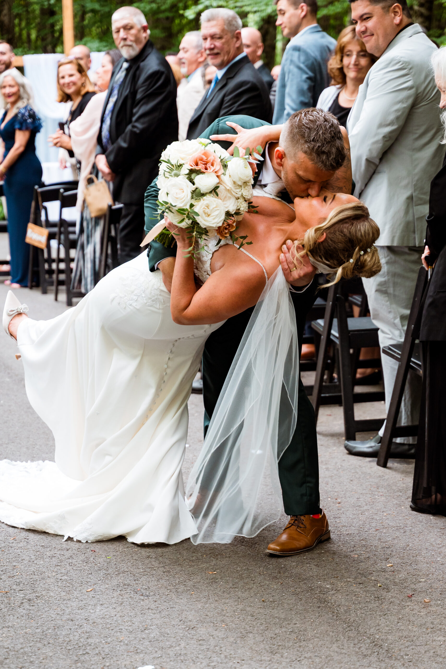 Groom dipping and kissing the bride at the end of their outdoor ceremony at Stonehurst at Hampton Valley in Hampton CT